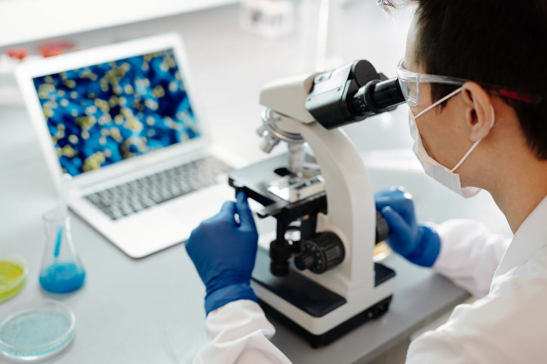 Scientist examining a sample under a microscope